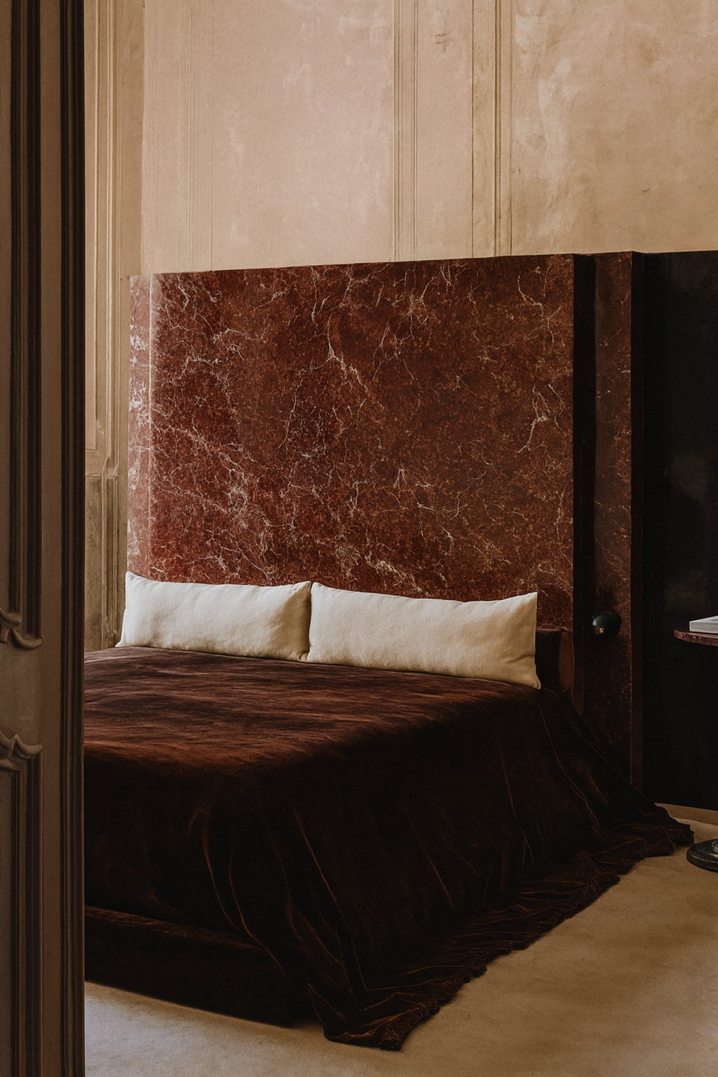Bed with a Rosso Levanto marble headboard